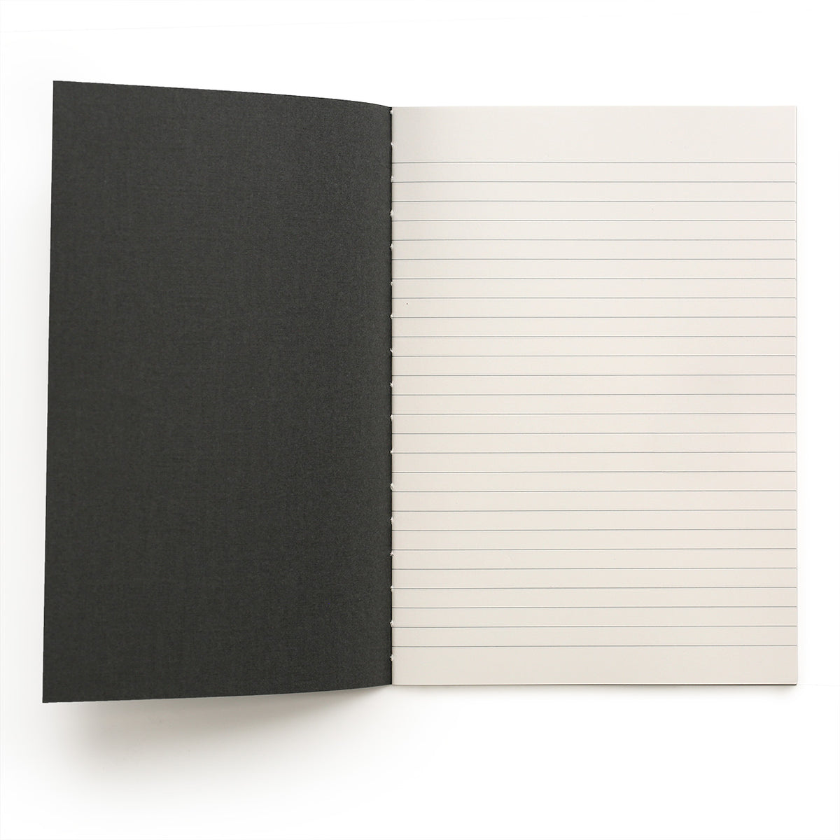 Inside front cover of the Apica A4 notebook showing that it can open very flat and has grey ruled lines and stitched spine