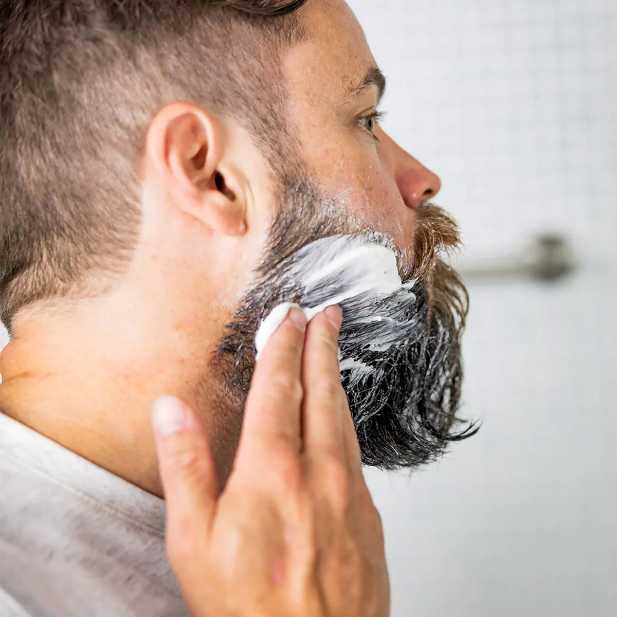 picture of a bearded man applying the mask to his beard 