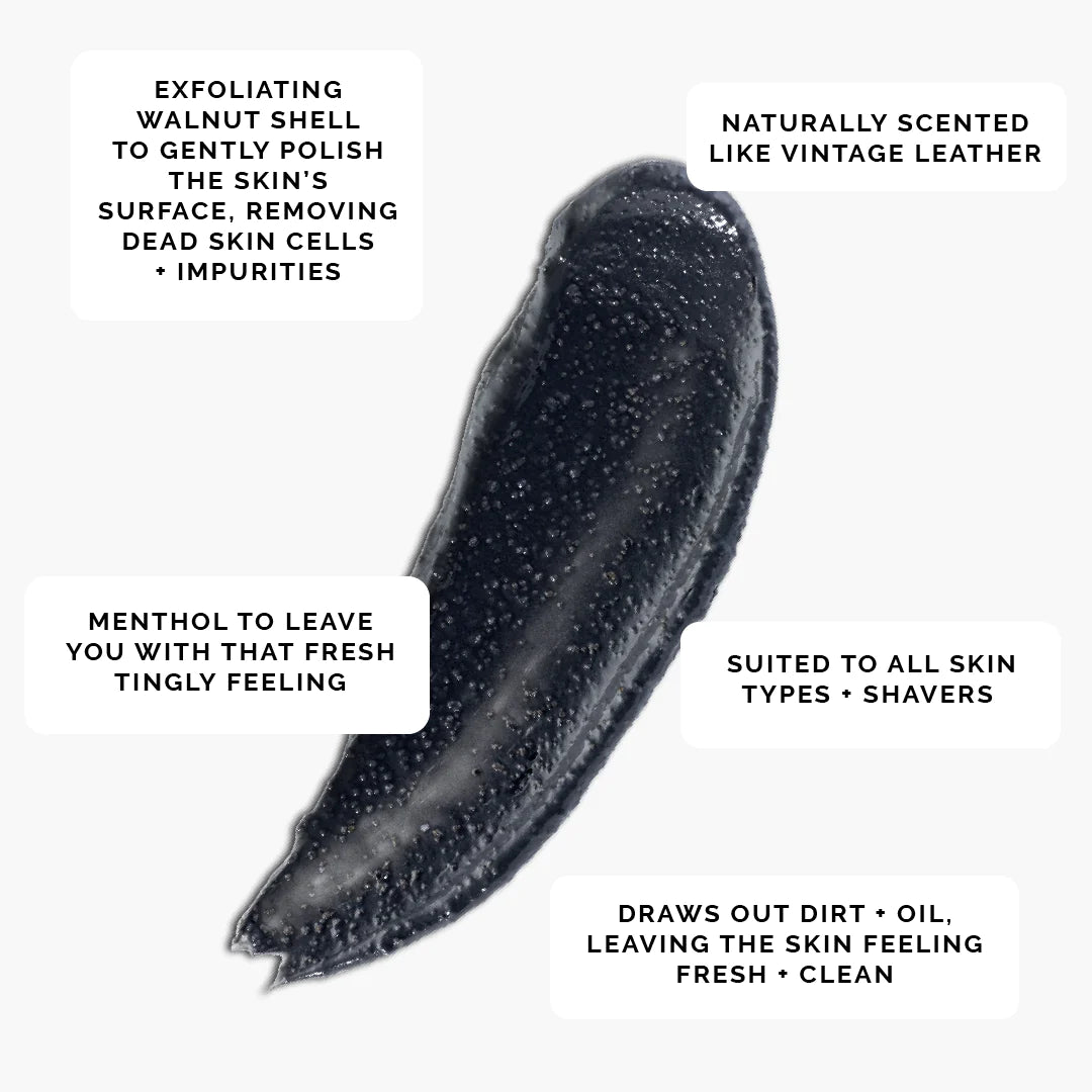 a thick smear of Black charcoal scrub showing the texture with small pieces - Exfoliating walnut shell - Naturally scented like vintage leather - includes menthol - Suited to all skin types and shavers 