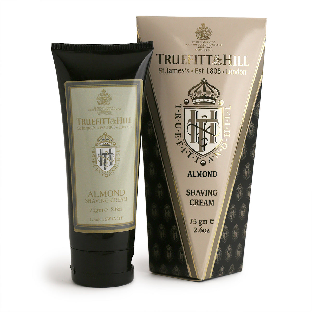 Truefitt &amp; Hill Almond shaving cream is a premium scent with cfreamy lather. Pictured  as black tube beside its irregular-shaped grey, gold and cream box