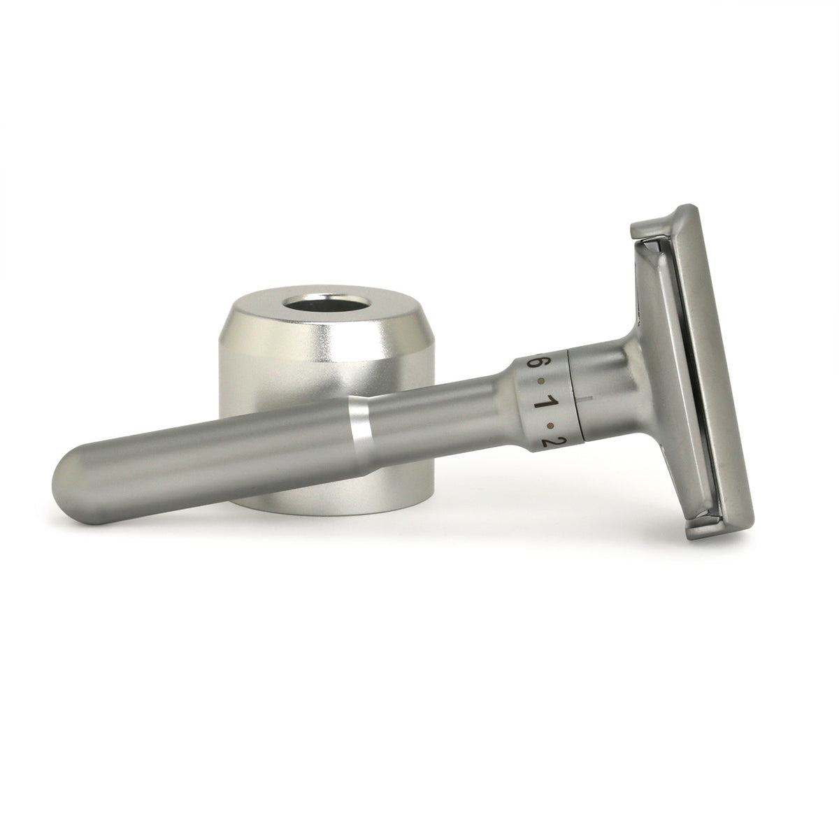 Adjustable safety razor with six settings in reclining position next to its stand base
