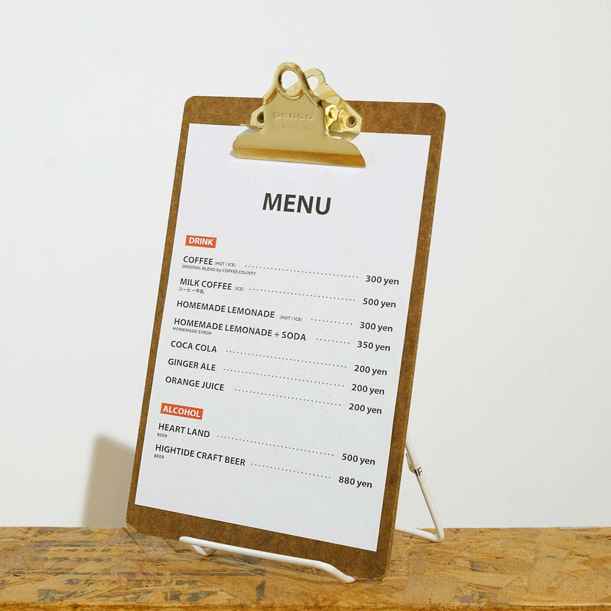 Menu on a clipboard with a wooden surface and white background