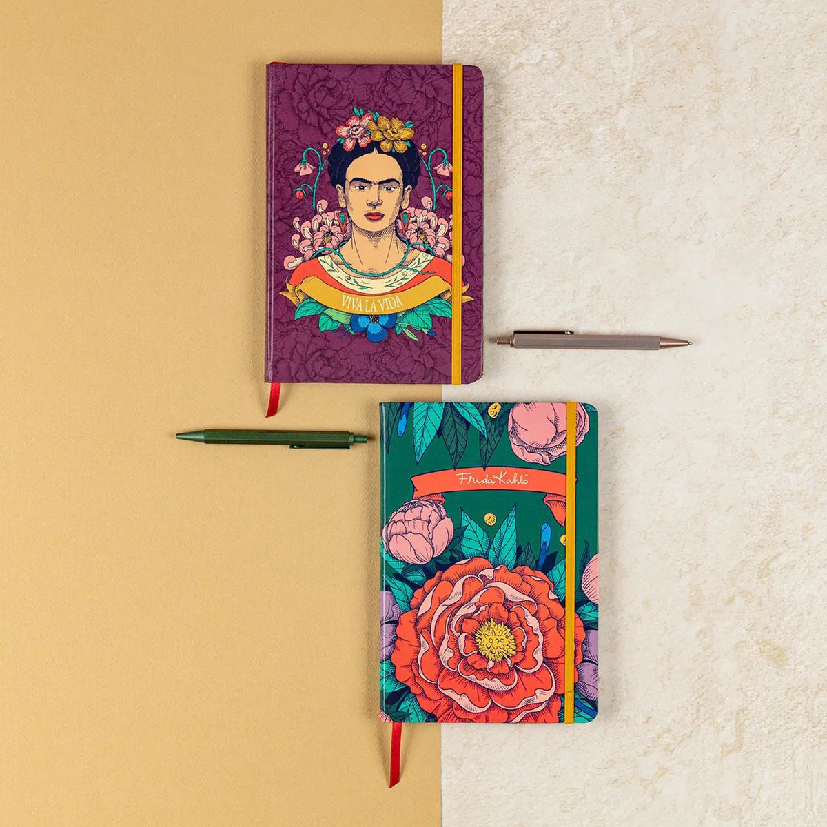 Two colorful notebooks with floral designs on a beige and white background