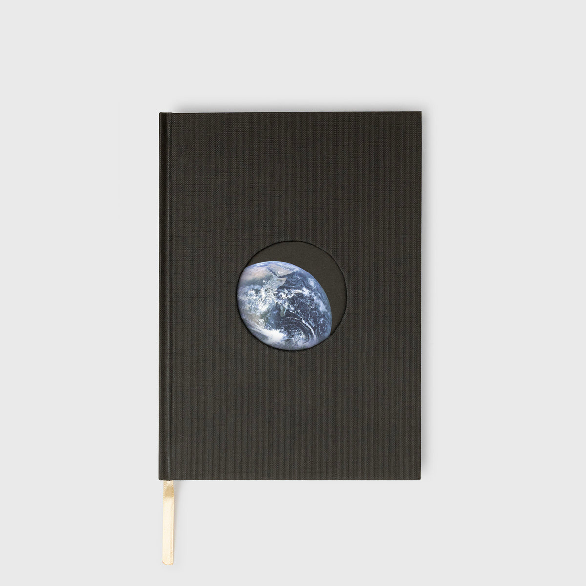 Black notebook with a circular cutout showing Earth on a white background