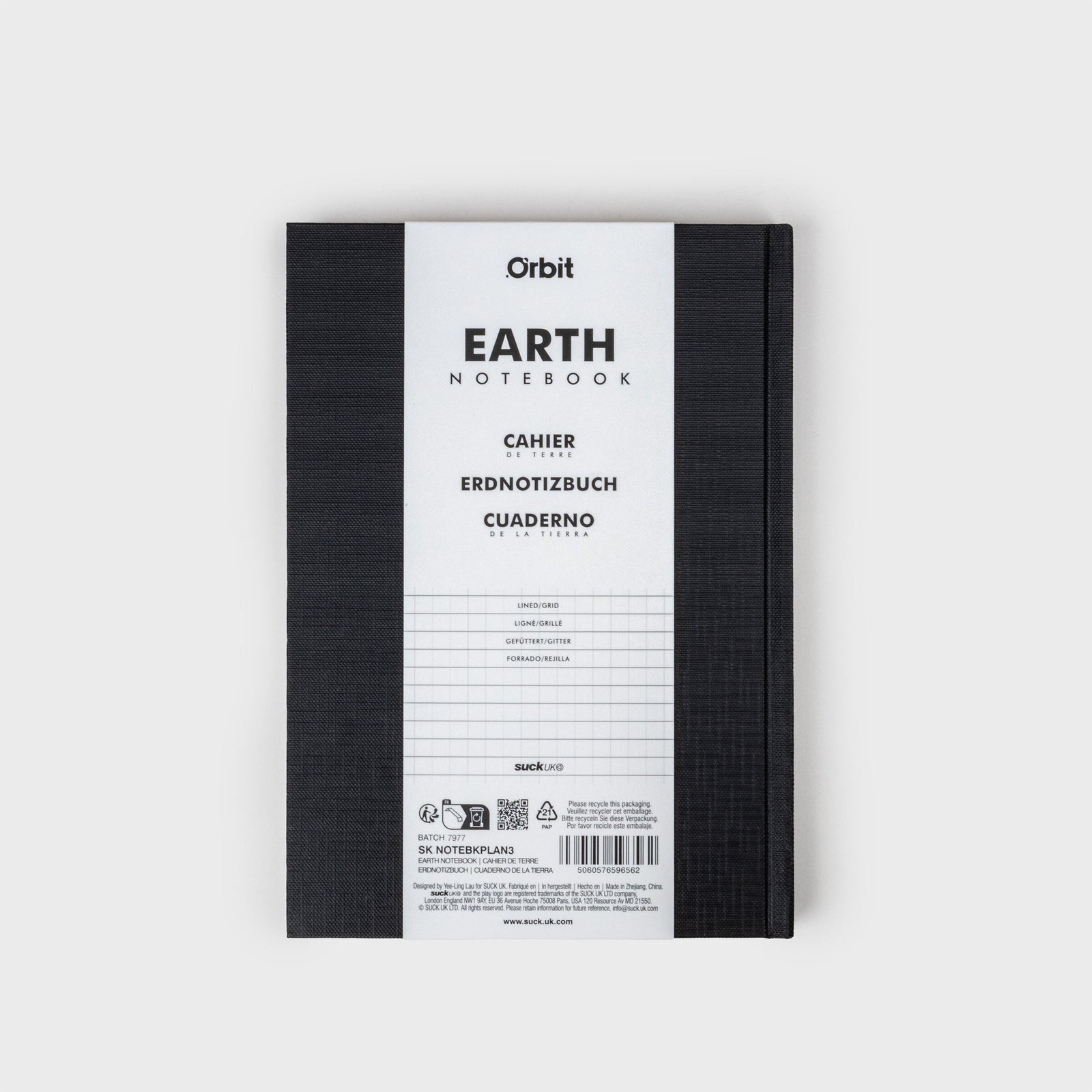 Black notebook with a circular cutout showing Earth on a white background