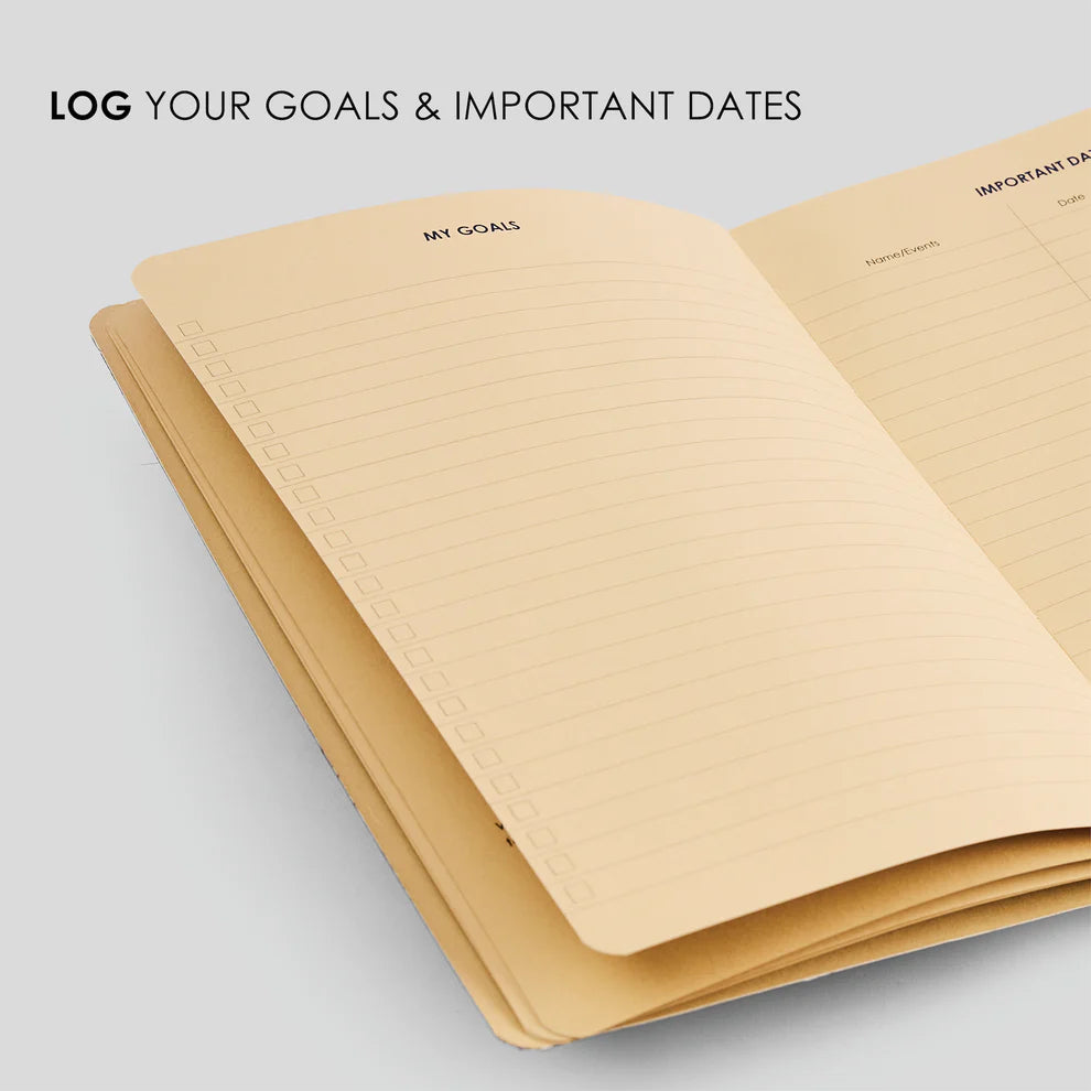 Open notebook with 'My Goals' and 'Important Dates' sections on a light gray background.