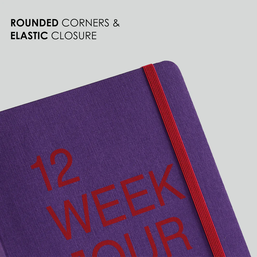 Purple notebook with red elastic closure and text on a light gray background