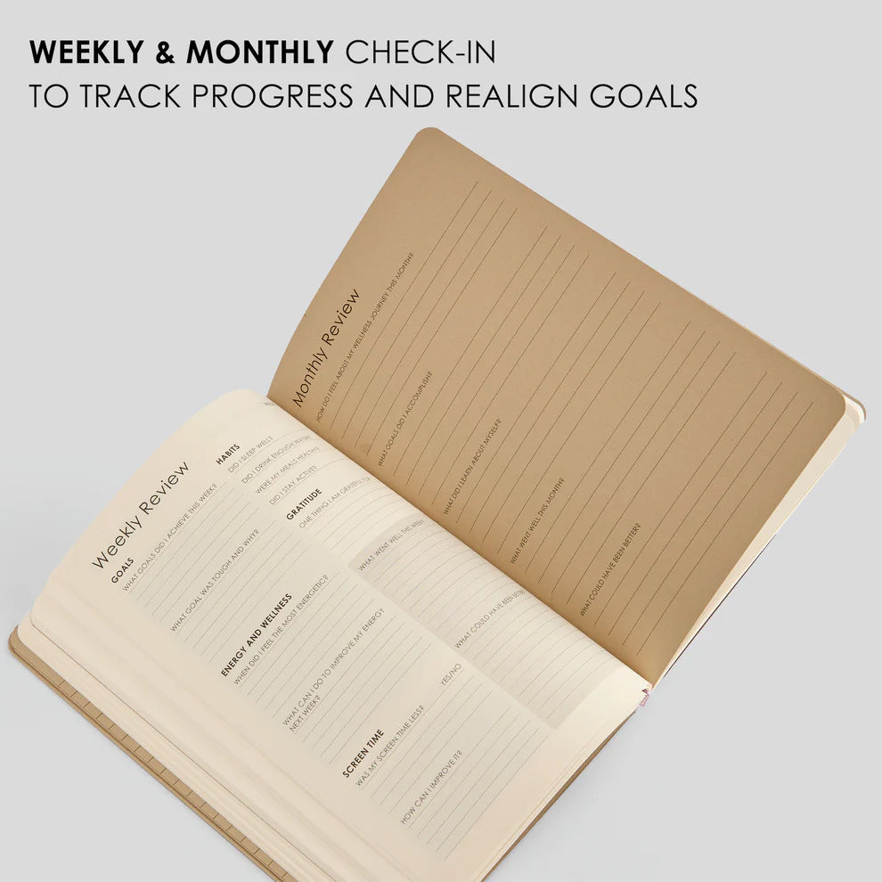 Open notebook with weekly and monthly check-in sections on a light gray background