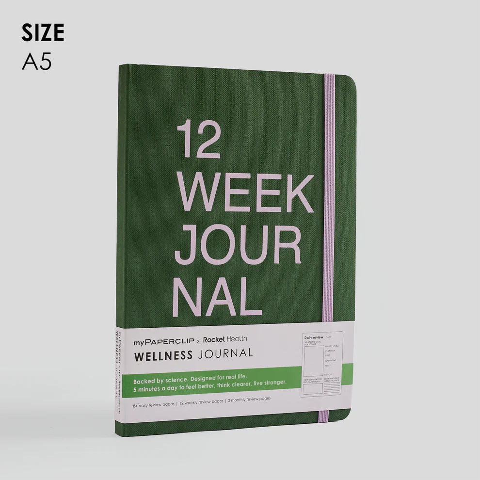 Green wellness journal with '12 Week Journal' text on a light gray background
