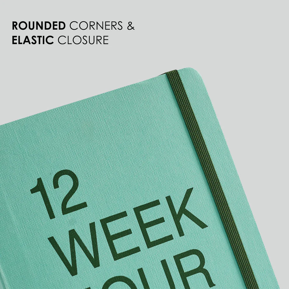 Teal notebook with '12 Week' text on a light gray background