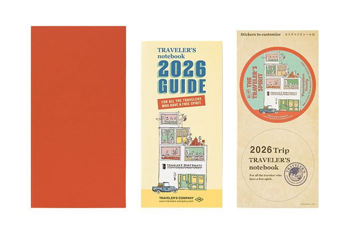 Orange diary cover, Travelers Notebok 2026 Guide, and thensticker sheetn which are all, packed together