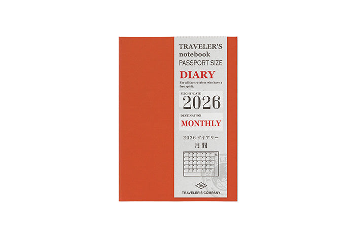 Orange travel diary with white label on a light gray background