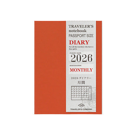 Orange travel diary with white label on a light gray background