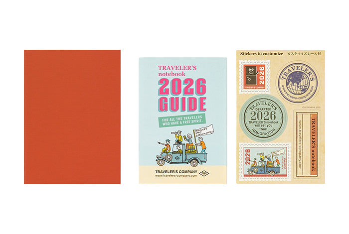 Traveler&#39;s notebook set with red cover, blue guidebook, and yellow sticker sheet on a white background