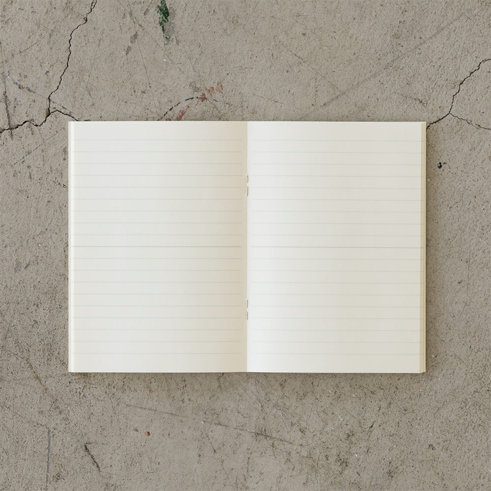 The open lined notebook on a cement slab