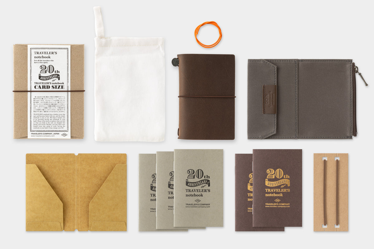 Collection of travel notebooks and accessories on a white background