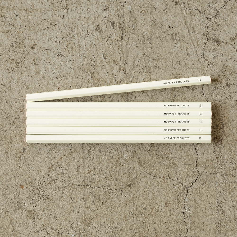 A pack of six MD Midori pencils with a beige color and text on the packaging that reads 'MD PAPER PRODUCTS' and 'NO.6 FLAT NOWHERE ELSE BUT HERE'.