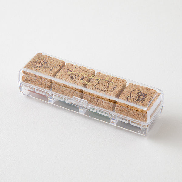 Set of cork stamps in a clear holder on a white background