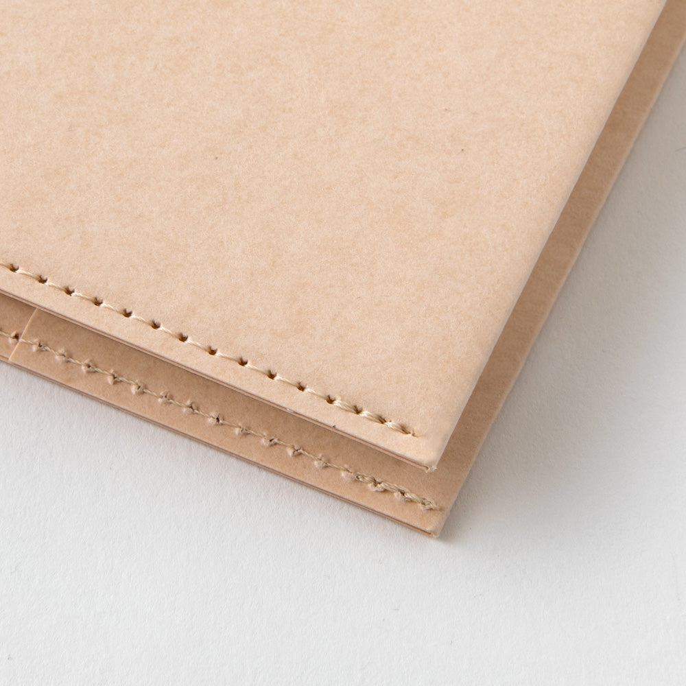 detail of the cover stitching on the paper notebook cover