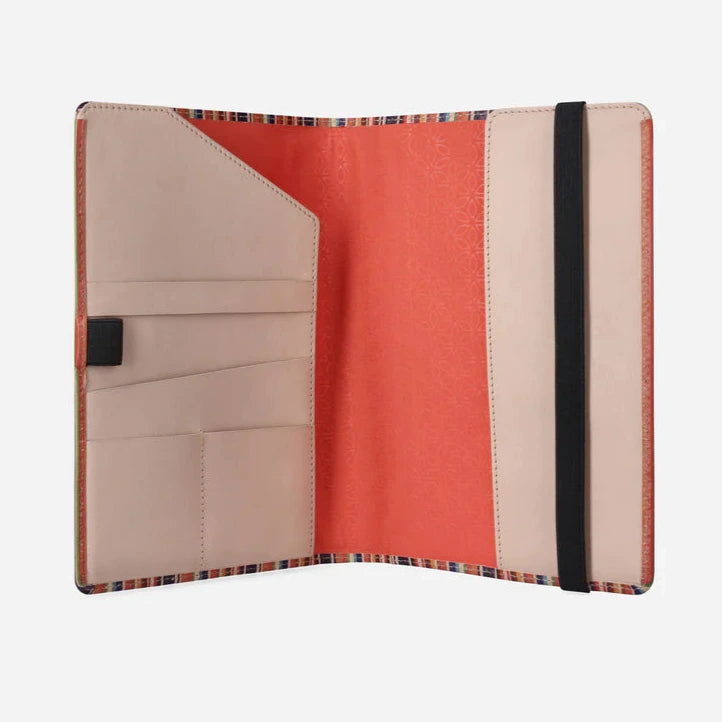 Inside view of the Lollipop Leather notebook cover with beige and apricot interior and elastic closure on a white background