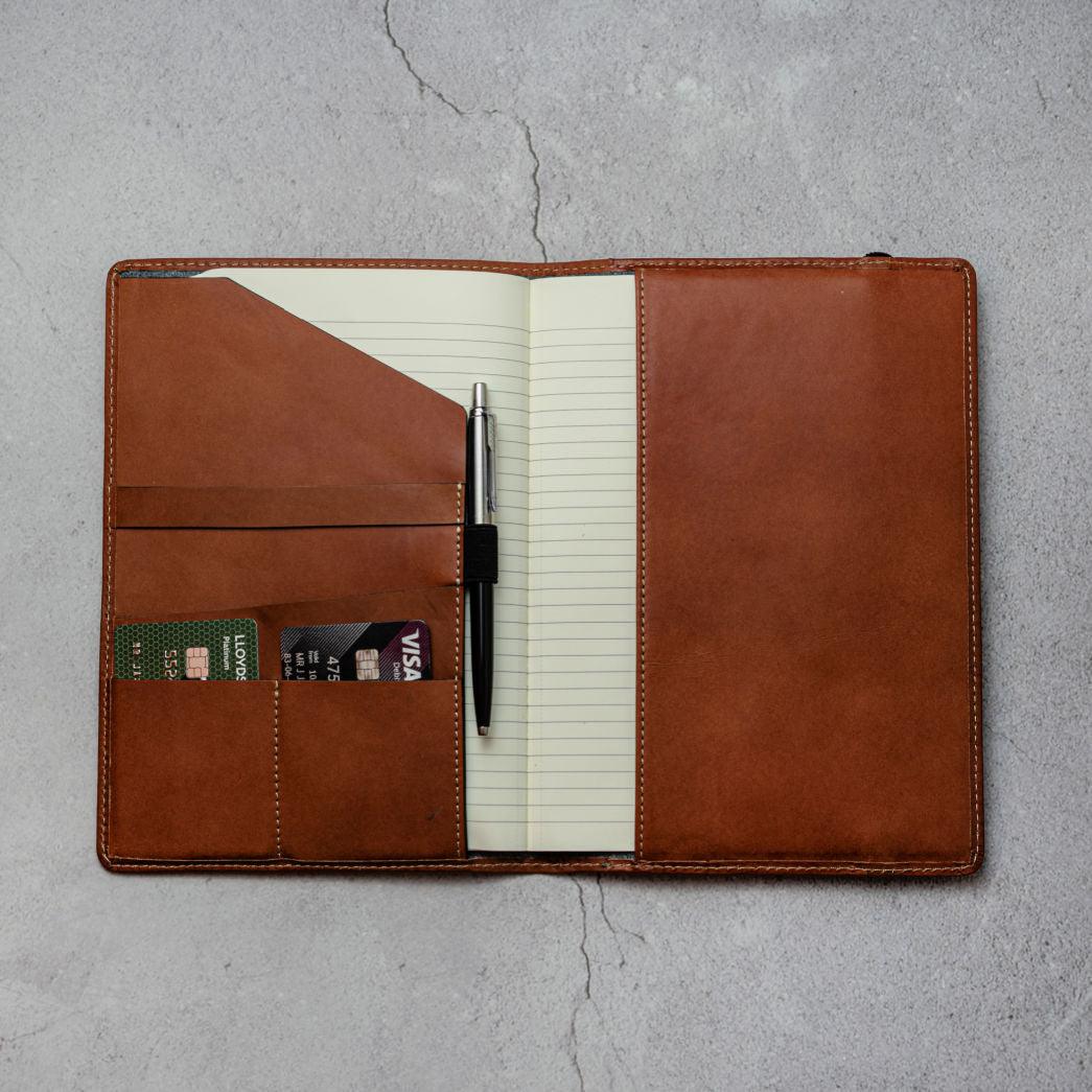 Inside of the Leather Journal cover showing how credit cards, a pen and a journal fit within