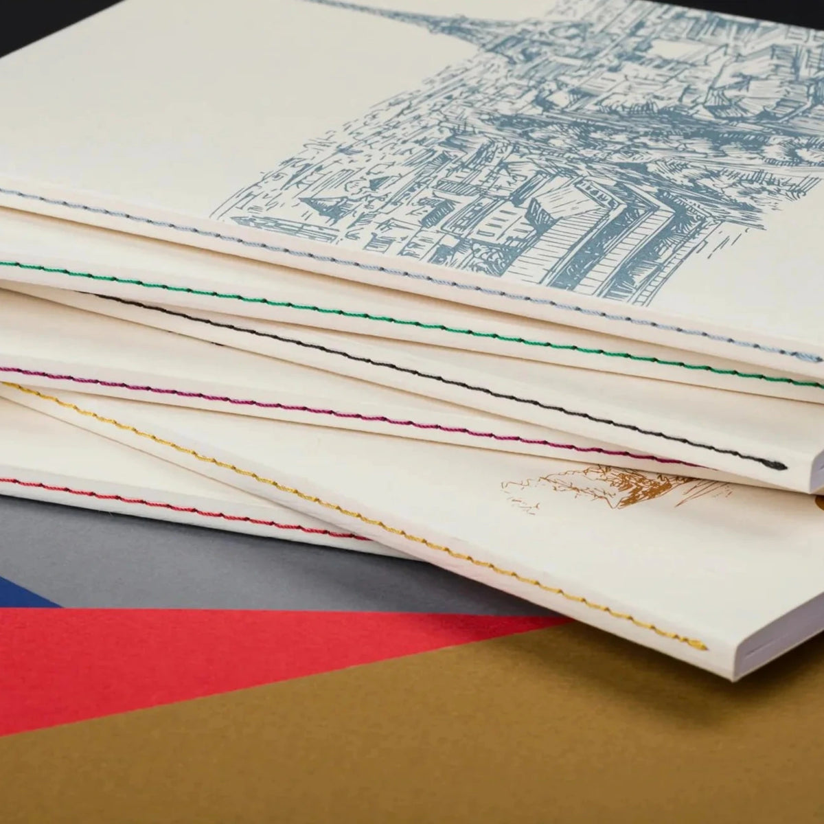 Stack of books with visible text and design on a colorful geometric background