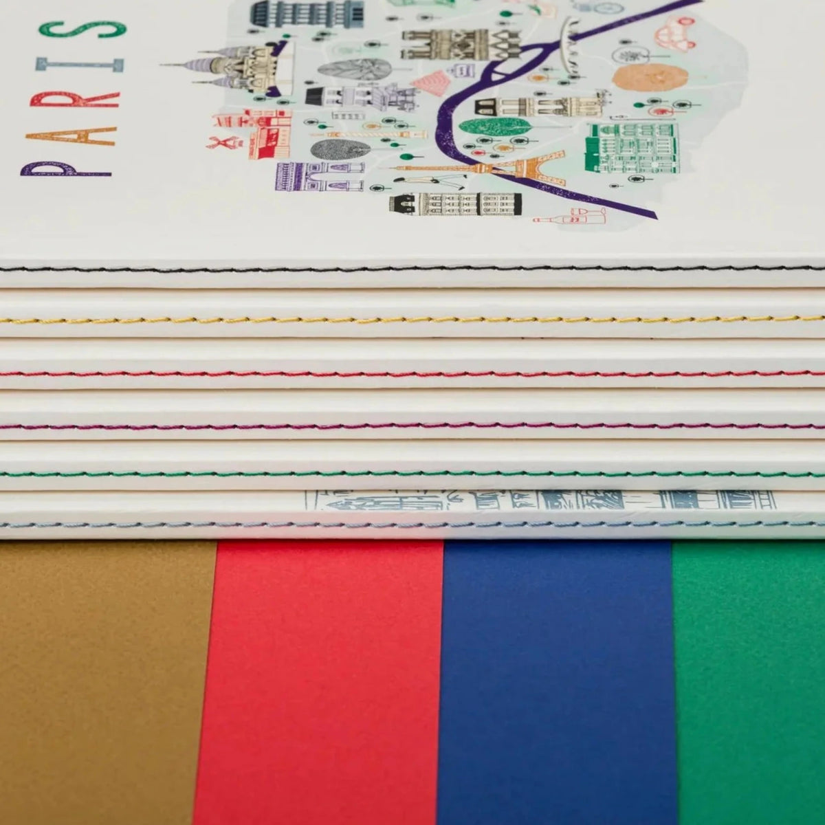 Stack of notebooks with a colorful cover design on a black background