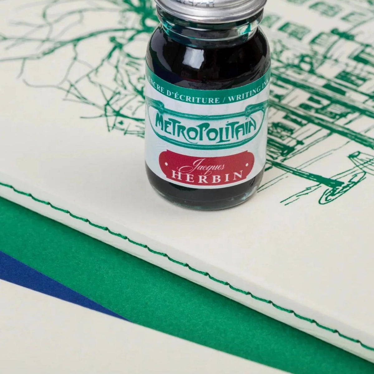 Bottle of Jacques Herbin Metropolitan ink on a map background