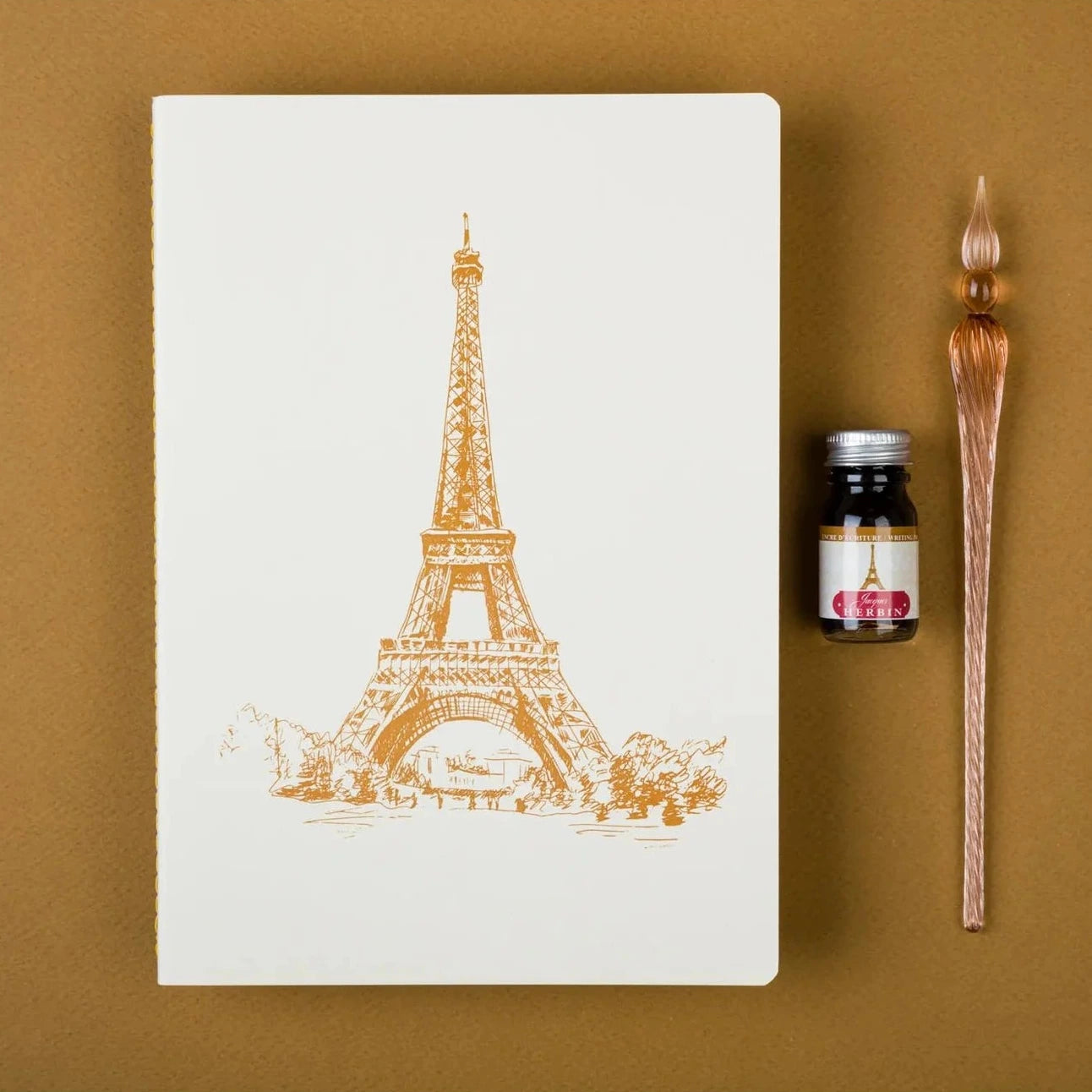 Notebook with gold Eiffel Tower design on a white background