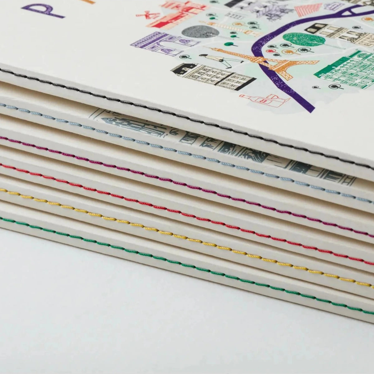 Stack of notebooks with colorful line patterns on a white background