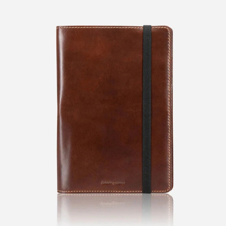 mocha leather notebook with a elastic closure on a white background