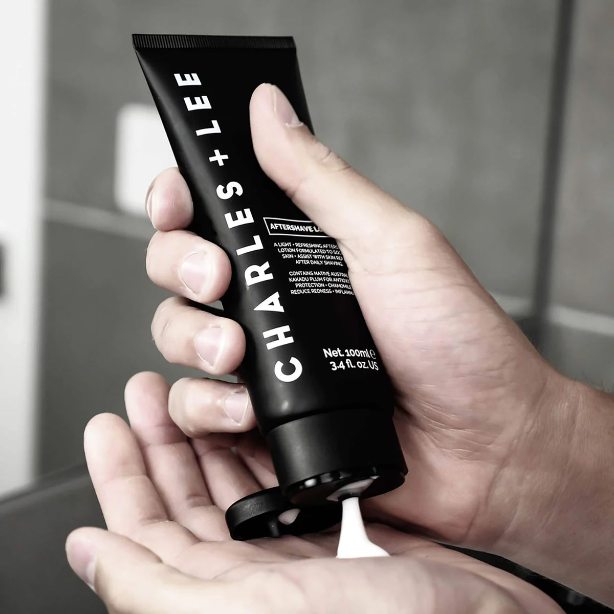 Charles &amp; Lee Aftershave Lotion being squeezed onto a man&#39;s hand