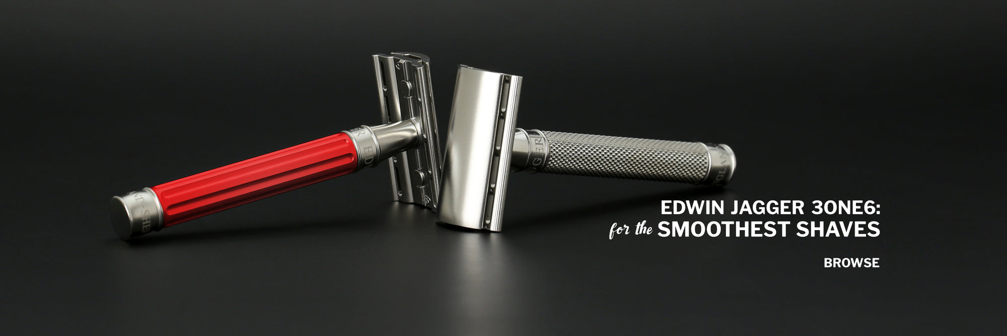 Two safety  razors viewed from the side facing each other head to head One has a red handle with pronounced ribs, the other has a knurled stainless steel handle. Text says Edwin Jagger 3ONE6: for the smoothest shaves