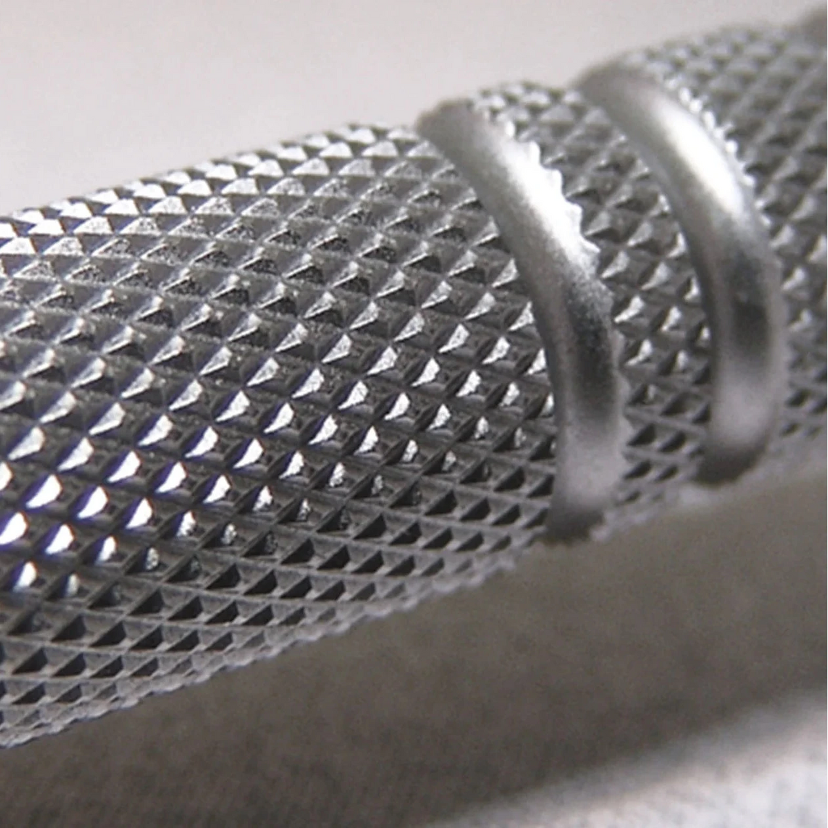 Close-up of a textured metal object on a light background