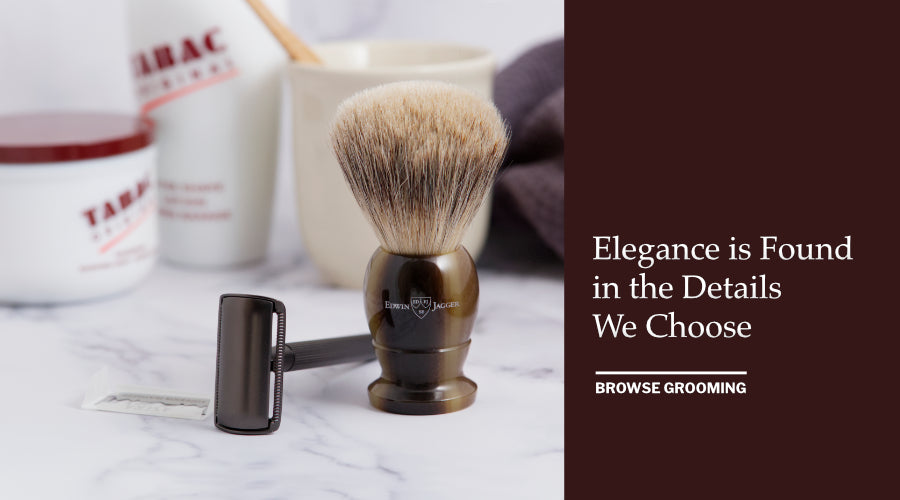 Shaving brush, Safety Razor and accessories on a marble surface with a dark waffle towel.