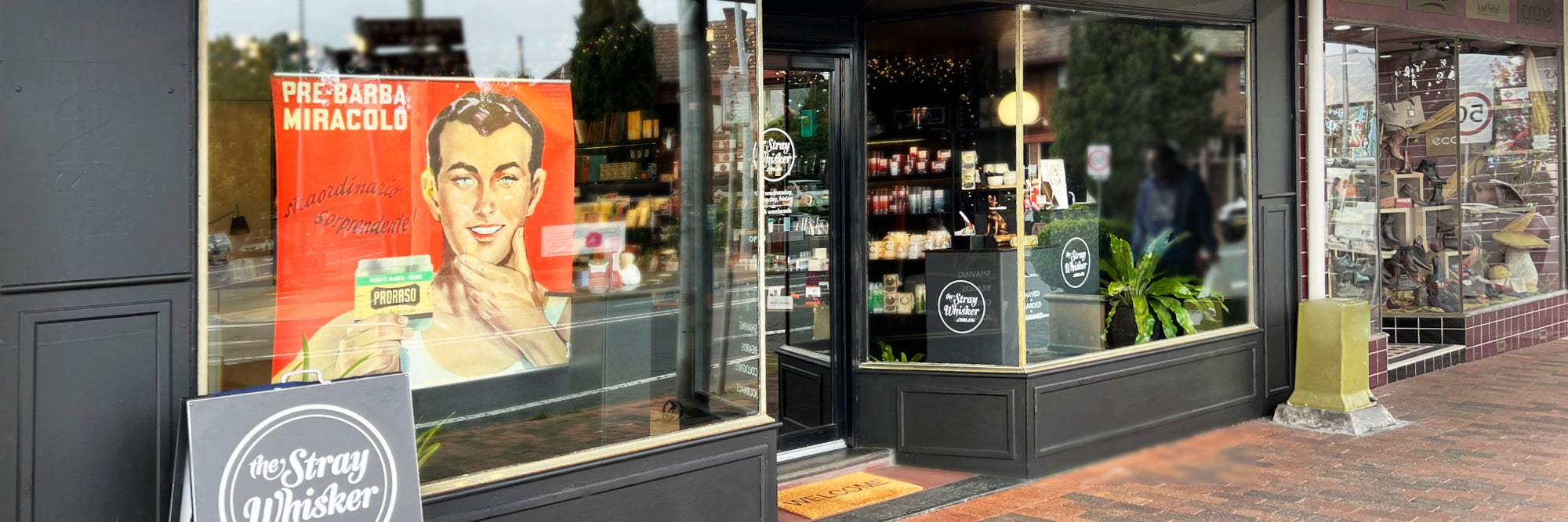 The Stray Whisker shopfront at 2 Govetts Leap Rd, Blackheath featuring a black interior and bright window displays