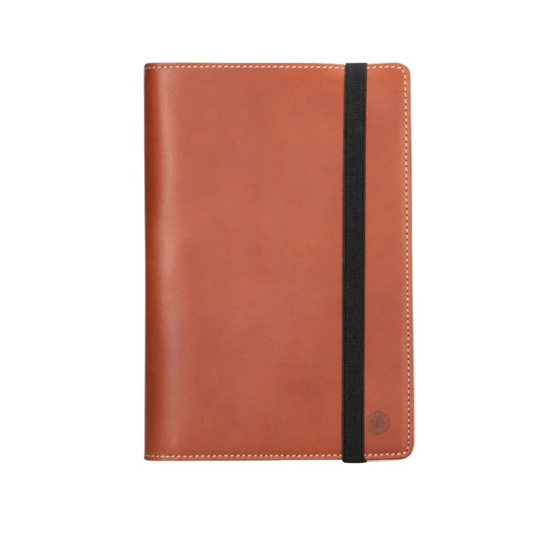 Tan leather notebook with a elastic closurre on a white background