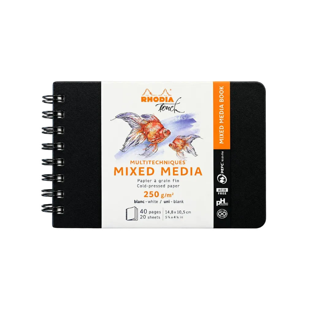 Rhodia Touch Mixed Media drawing book held in hands, showing the front cover with goldfish artwork and product details, set against a blurred gray background.