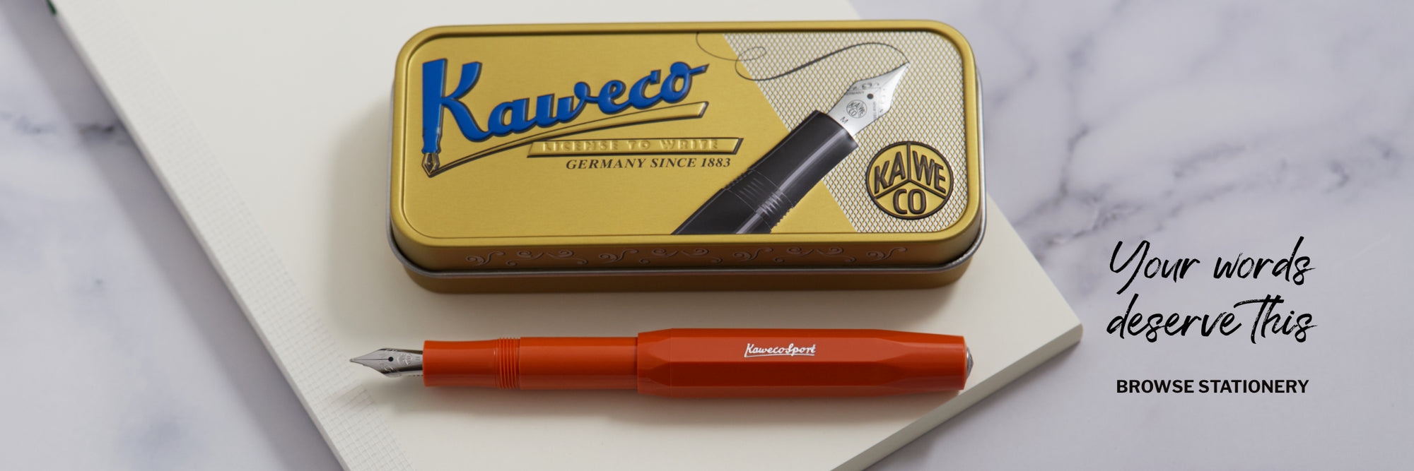 Kaweco Pen tin with Fox coloured Fountain pen resting on a MD Paper notebook with the title, Your Words Deserve This
