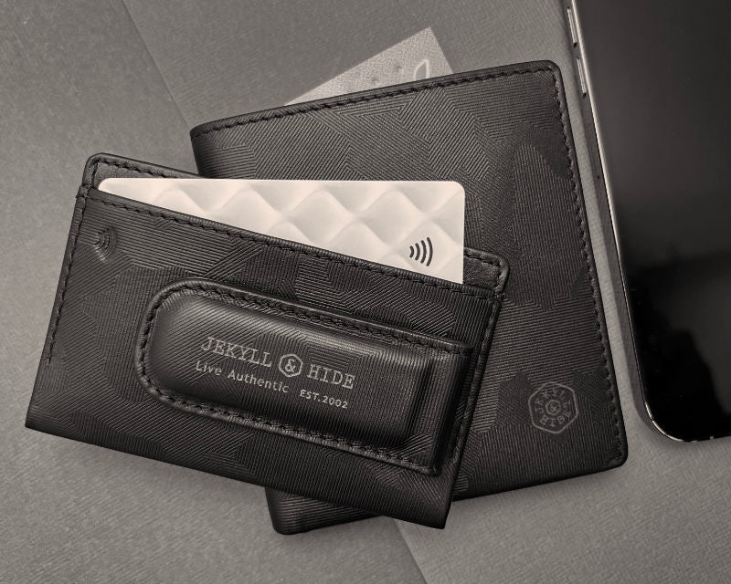 Black leather wallet with card holder and 'Jekyll & Hide' branding on a gray background