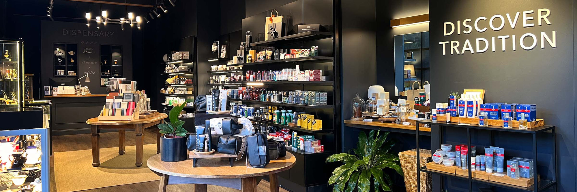 Interior of The Stray Whisker shop which is in Leura, Blue Mountains NSW. It's a dark interior with oak display tables in the centre and comprises shaving, beard and journaling products