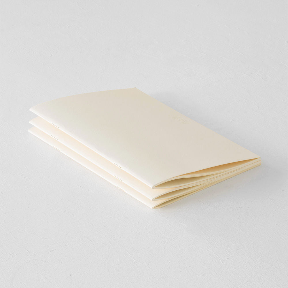 Three quarter view of three stacked and angled light notebooks