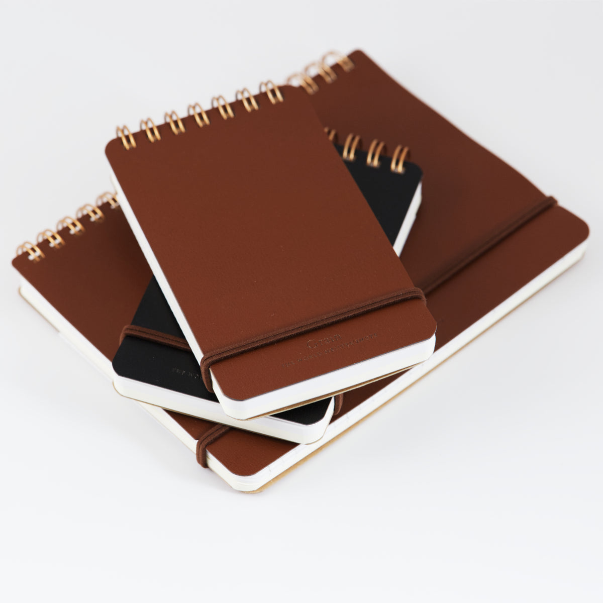 Stack of midori Grain Notebooks, B6 and Memo (pocket) sizes, with brown and black covers.