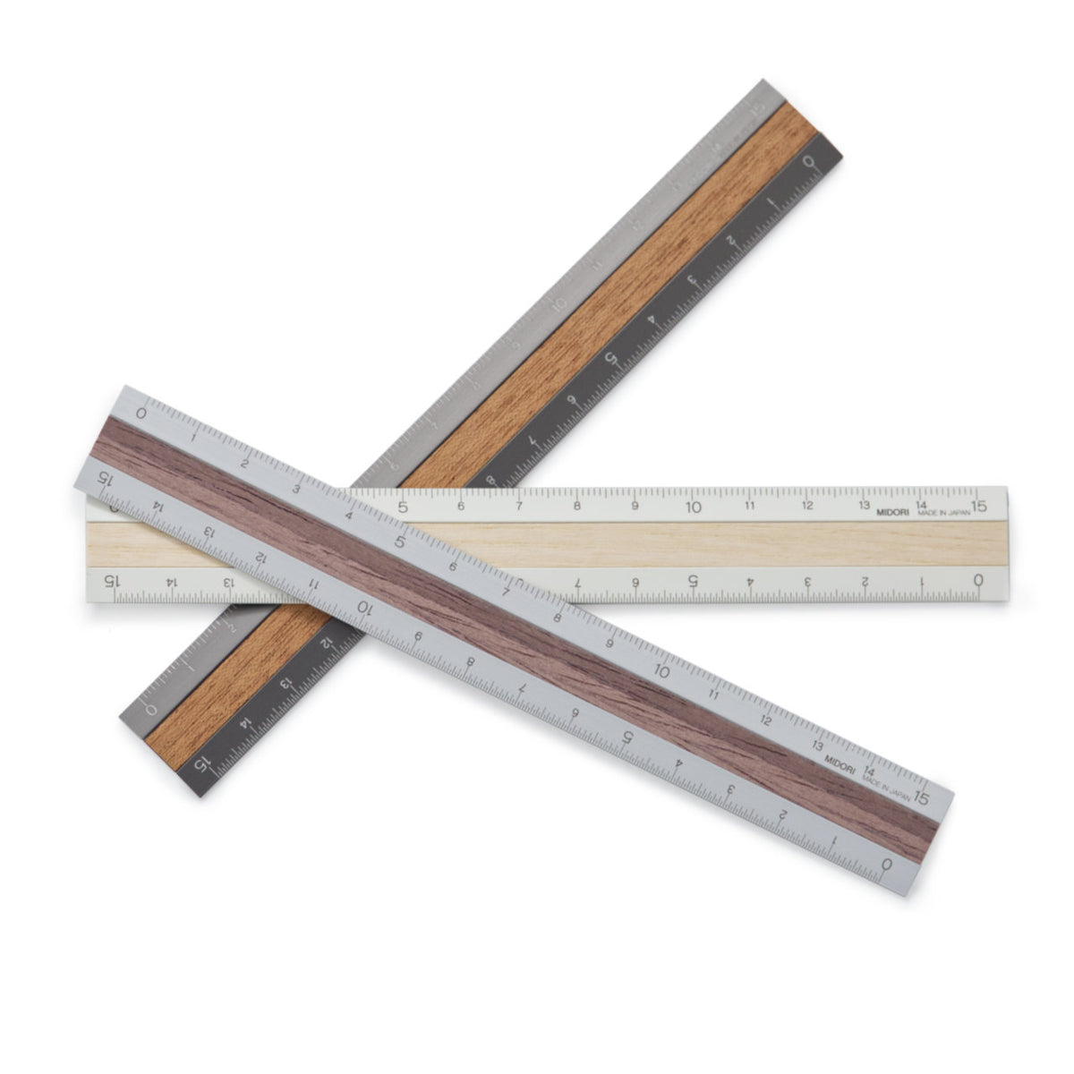 A stack of aluminium rulers with wood inlaid down the centre, in various shades of light and dark timber