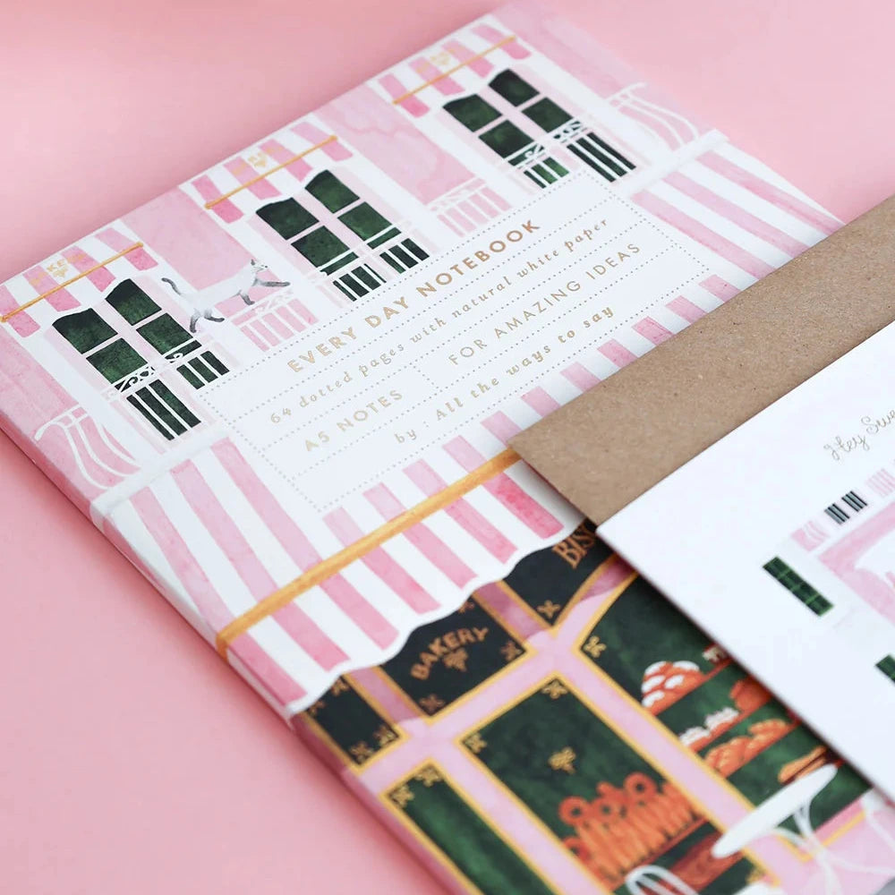 Notebook with a decorative cover on a pink background