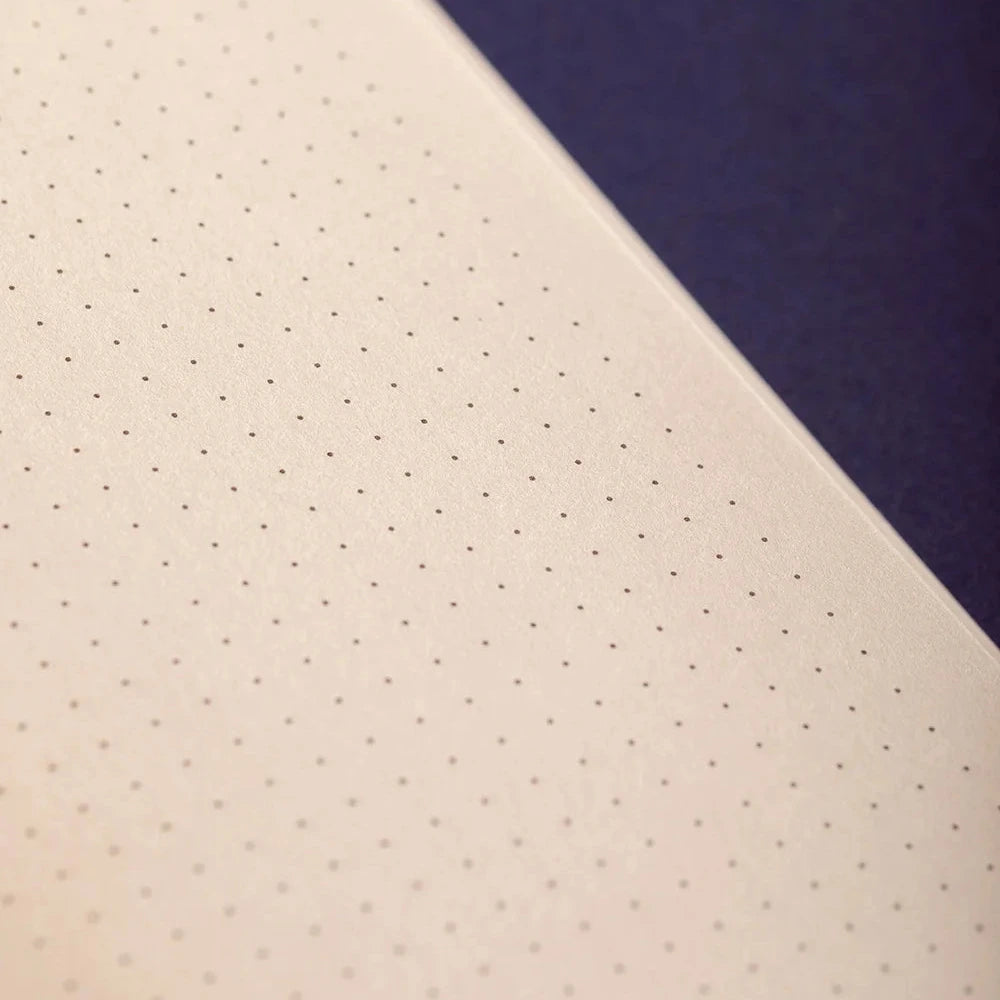 Two fabric swatches, one beige with a subtle pattern and the other navy blue, on a white background.