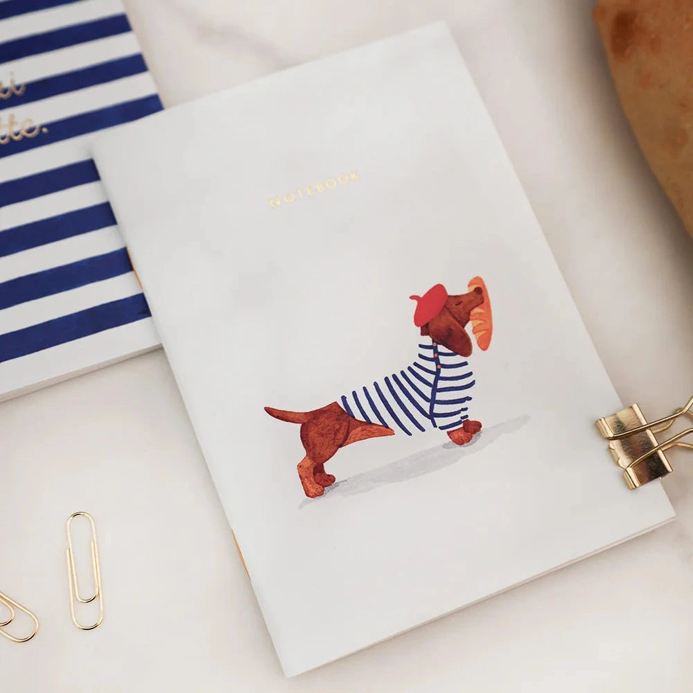 Notebook with a dog illustration on a white surface