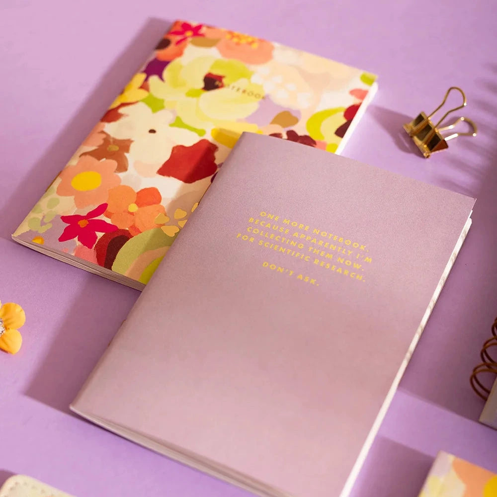 A floral patterned notebook with a lavender page insert, displayed on a clean white background.
