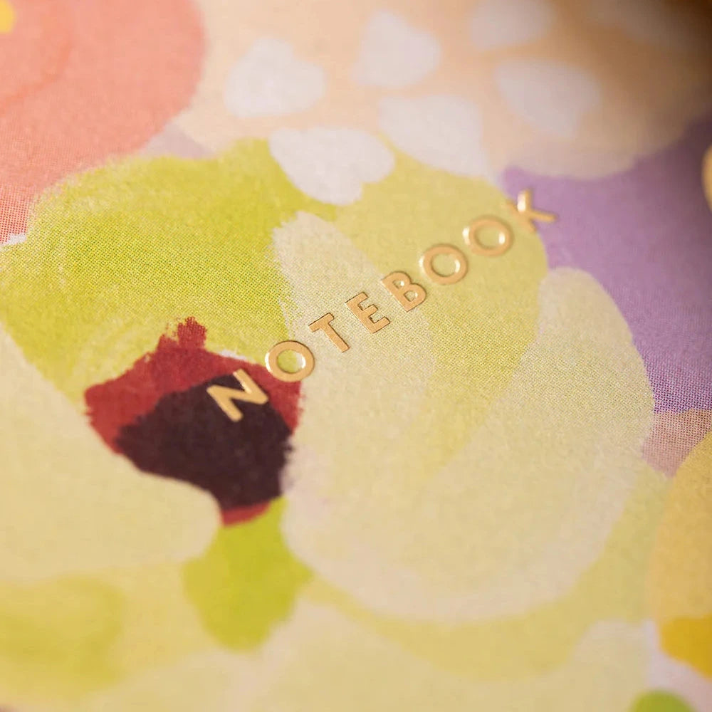 Notebook with colorful design featuring a character and the word 'NOTEBOOK'.