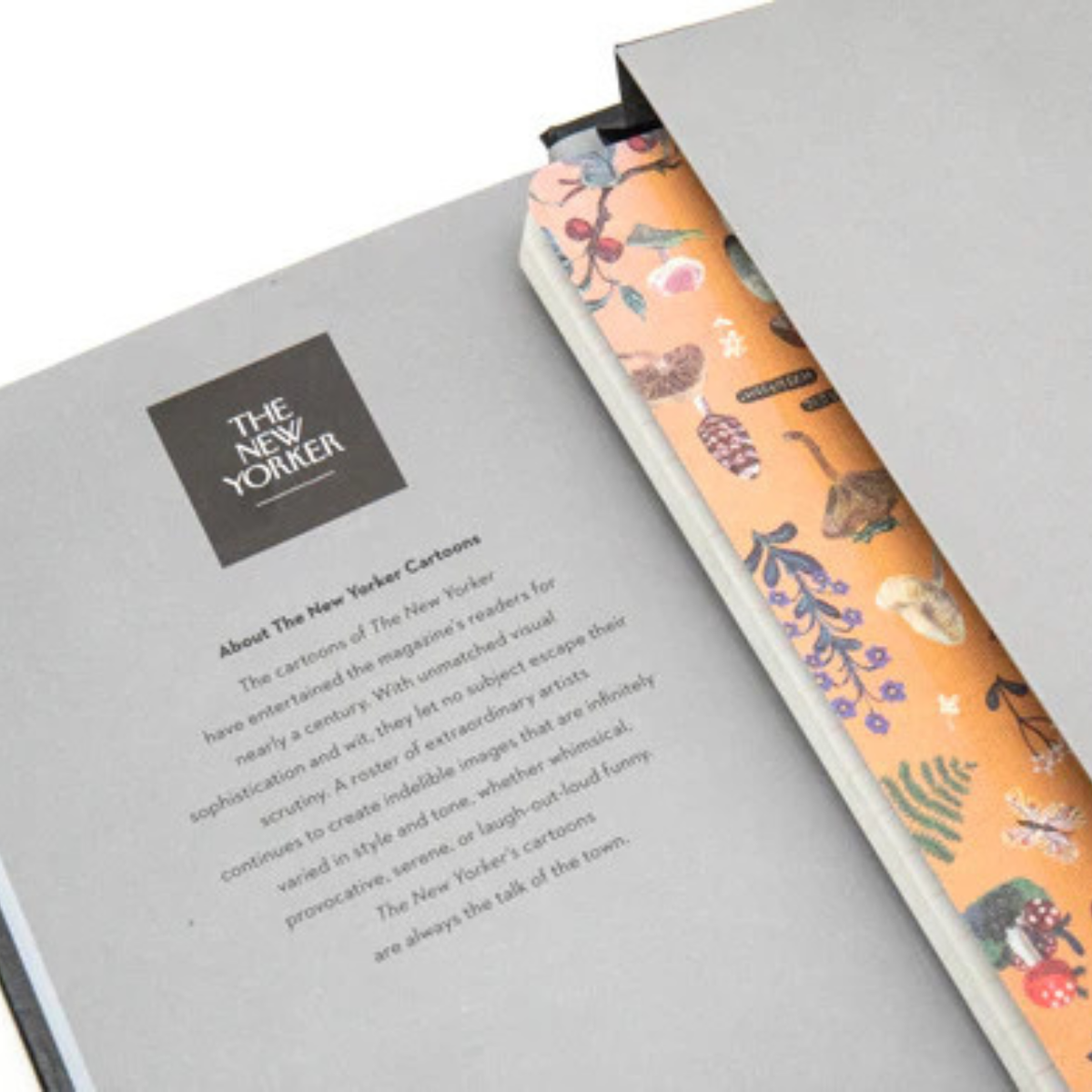 Book with a floral patterned bookmark on a gray background